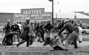 FILE - In this March 7, 1965 file photo, state troopers use clubs against participants of a civil rights voting march in Selma, Ala. At foreground right, John Lewis, chairman of the Student Nonviolent Coordinating Committee, is beaten by a state trooper. The day, which became known as "Bloody Sunday," is widely credited for galvanizing the nation's leaders and ultimately yielded passage of the Voting Rights Act of 1965. (AP Photo/File) ORG XMIT: NY516